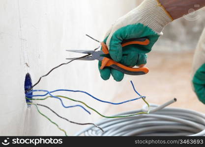 worker puts the wires in the wall