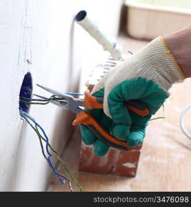 worker puts the wires in the wall