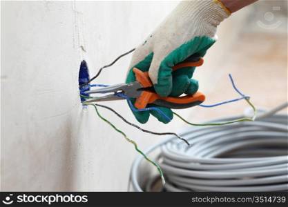 worker puts the wires in the wall