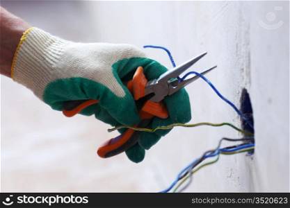 worker puts the wires in the wall