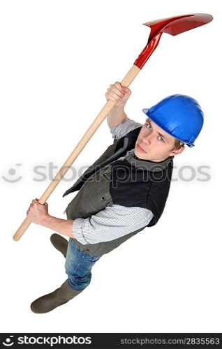 Worker raising spade in the air