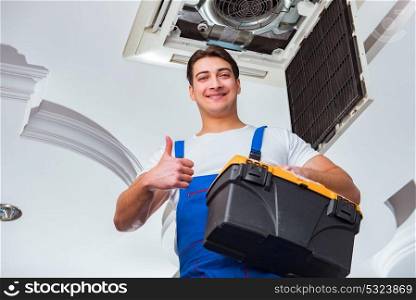 Worker repairing ceiling air conditioning unit