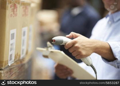 Worker Scanning Package In Warehouse