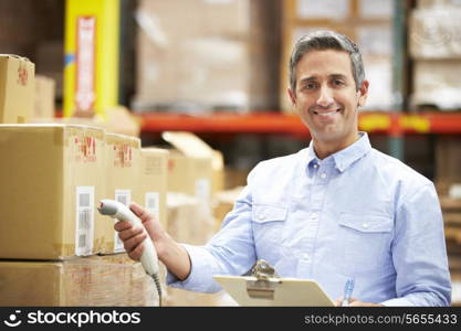 Worker Scanning Package In Warehouse