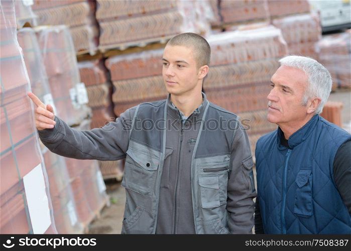 Worker showing building materials to customer