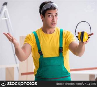 Worker showing the importnace of wearing noise cancelling headphones. Worker showing the importnace of wearing noise cancelling headph