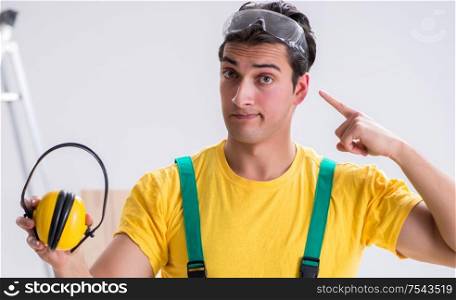 Worker showing the importnace of wearing noise cancelling headphones. Worker showing the importnace of wearing noise cancelling headph