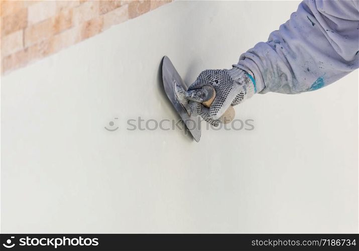 Worker Smoothing Wet Pool Plaster With Trowel.