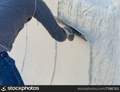 Worker Smoothing Wet Pool Plaster With Trowel.