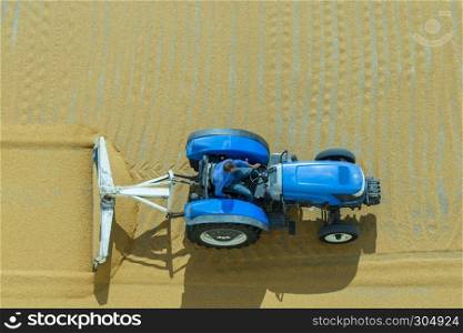Worker spreads bulgur wheat on a field with conventional techniques for drying under the sun in Gaziantep,Turkey.03 September 2016. Bulgur wheat processing in Gaziantep,Turkey