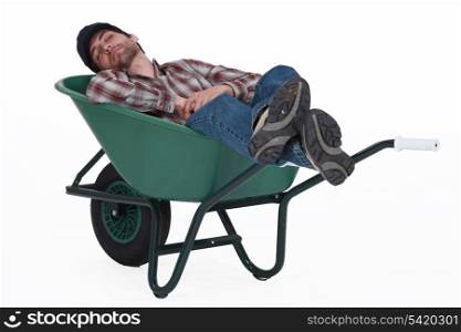 Worker taking a nap in wheelbarrow