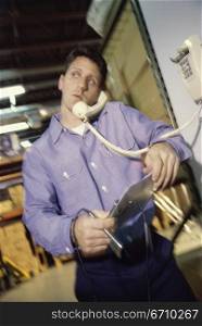 Worker talking on a telephone