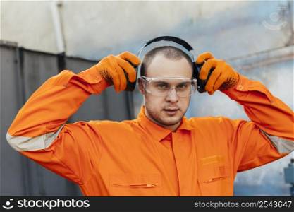 worker uniform with headphones protective glasses