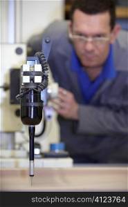 worker using a multisensor touch probe to inspect measurements
