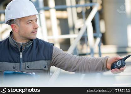 worker using a walkie talkie