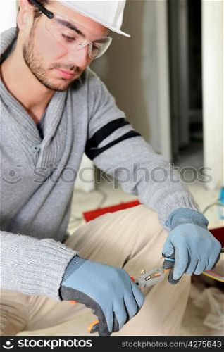 Worker using wire cutters