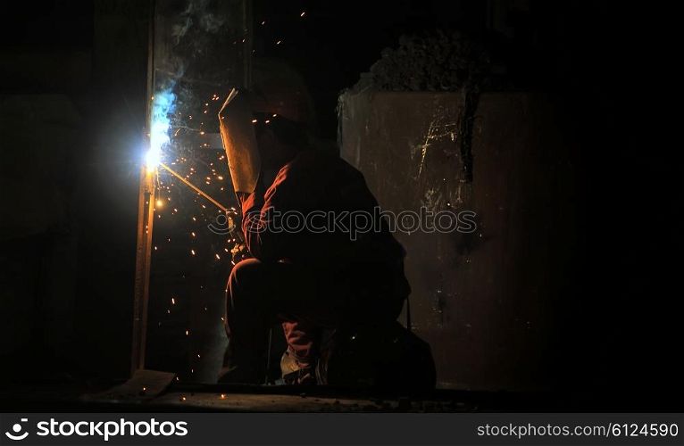 worker welding steel and sparks