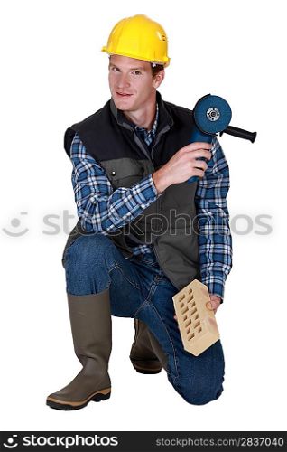 Worker with a brick and grinder