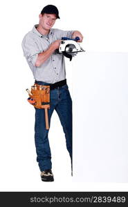 Worker with a circular saw and blank board