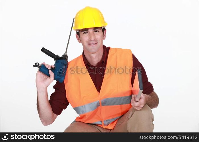 Worker with a masonry drill