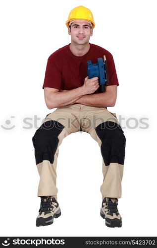 Worker with an electric sander