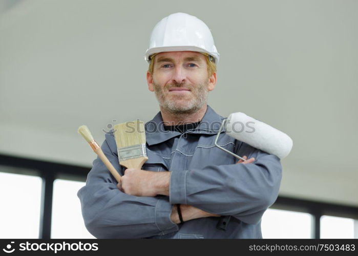 worker with brushes in hand