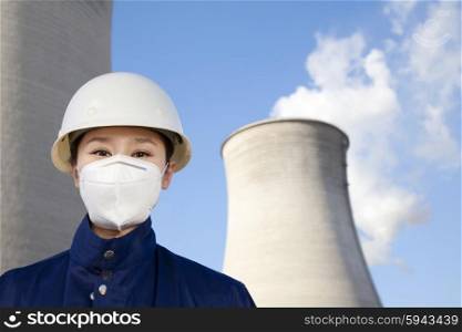 Worker with hardhat and mask at power plant