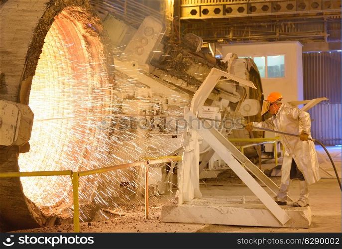 worker with hot steel in plant