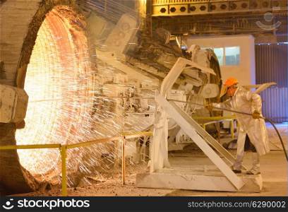worker with hot steel in plant