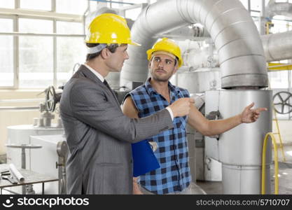 Worker with manager inspecting industrial area