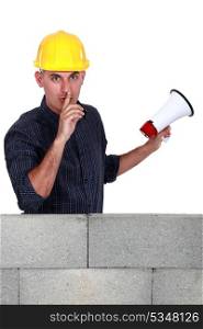 Worker with megaphone pleading silence
