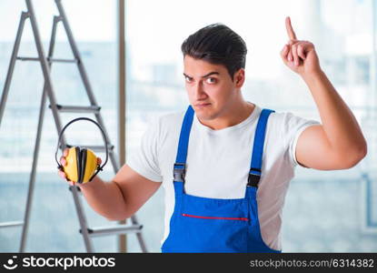 Worker with noise cancelling headphones