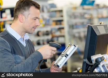 worker with portable barcode scanner in warehouse