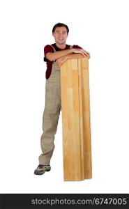 Worker with wooden floorboards