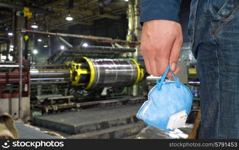 Worker . Worker with protective respirator at man hands at industrial factory