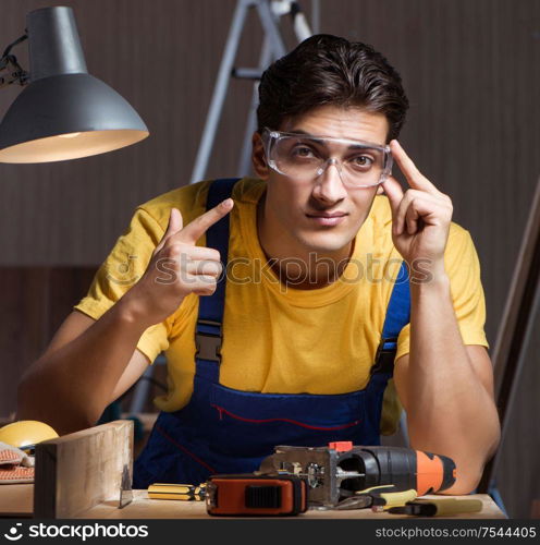 Worker working in repair workshop in woodworking concept. The worker working in repair workshop in woodworking concept