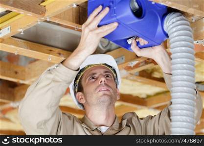 worker working with ventilation pipes