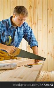 worker works with handsaw