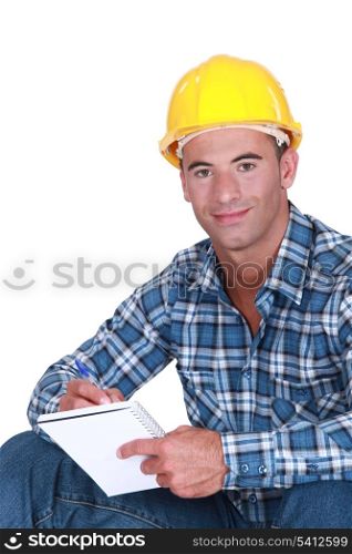 Worker writing in notebook