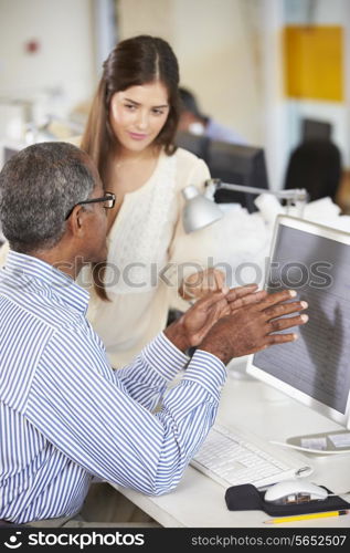 Workers At Desks In Busy Creative Office