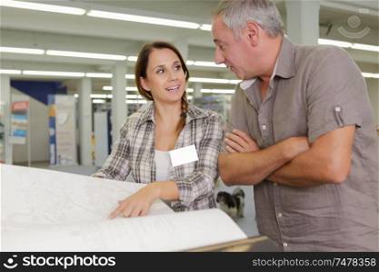 workers colleague looking at plans