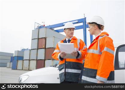 Workers conversing in shipping yard