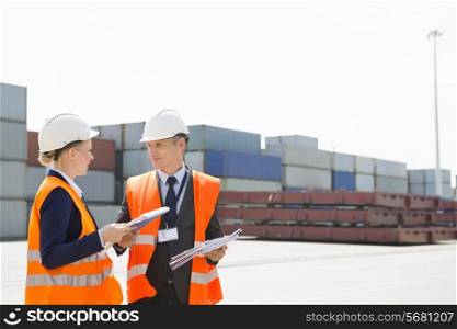 Workers discussing in shipping yard