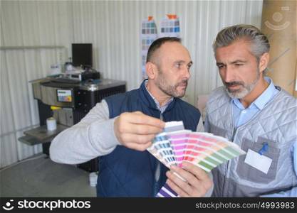 workers holding a color palette