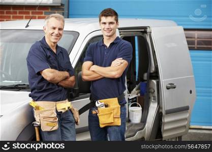 Workers In Family Business Standing Next To Van