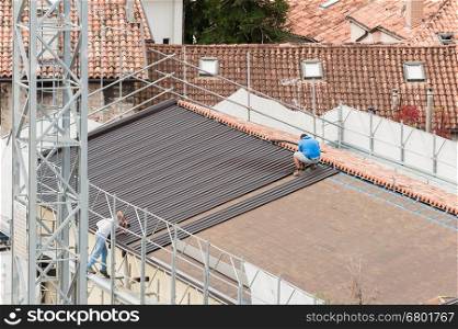Workers in the construction of a roof. Building renovation.