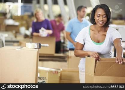 Workers In Warehouse Preparing Goods For Dispatch