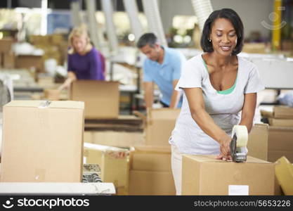 Workers In Warehouse Preparing Goods For Dispatch