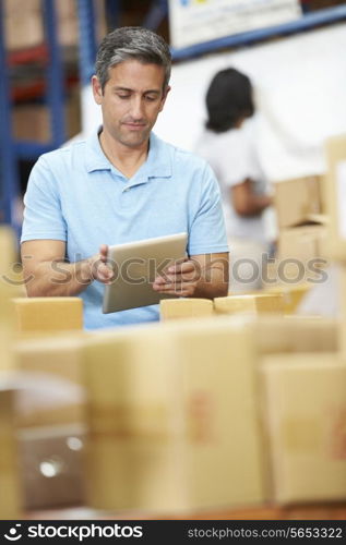 Workers In Warehouse Preparing Goods For Dispatch