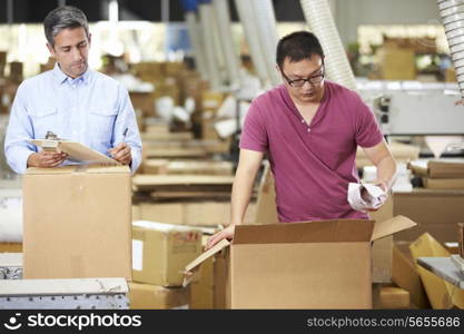 Workers In Warehouse Preparing Goods For Dispatch